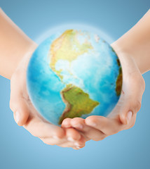 Image showing close up of human hands with earth globe