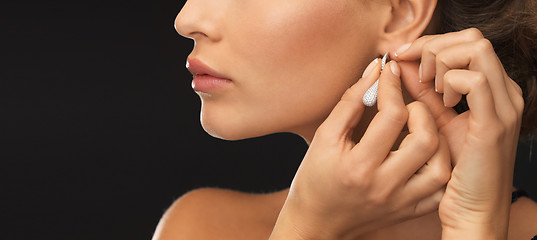 Image showing woman wearing shiny diamond earrings