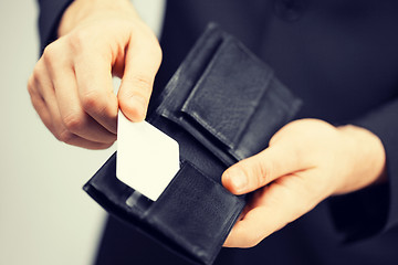 Image showing man in suit holding credit card