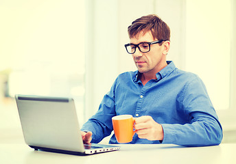 Image showing man working with laptop at home