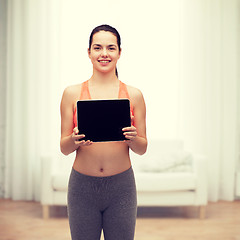 Image showing sporty woman with tablet pc blank screen