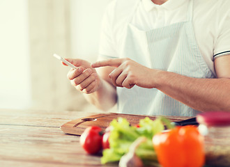 Image showing closeup of man pointing finger to smartphone