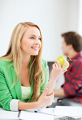 Image showing student girl with green apple in college