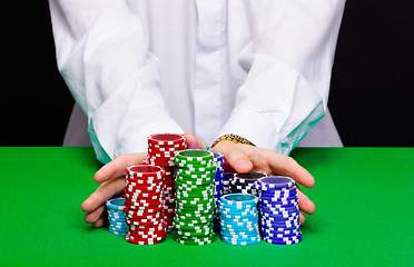 Image showing Man puts in the casino. Hand with chips