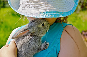 Image showing Rabbit gray on hands of girl in hat