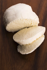 Image showing Sliced mozzarella on wooden board 