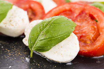 Image showing Caprese salad with mozzarella, tomato, basil and balsamic vinega