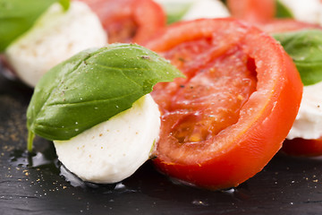 Image showing Caprese salad with mozzarella, tomato, basil and balsamic vinega