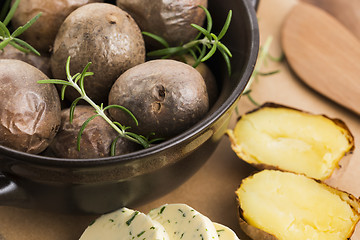 Image showing  baked potatoes with herbs butter
