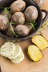 Image showing  baked potatoes with herbs butter