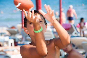 Image showing  The boy plays with a ball