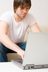 Image showing young man home with laptop