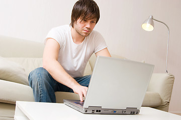 Image showing young man home with laptop