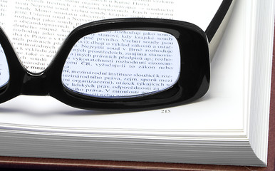 Image showing Glasses on a book