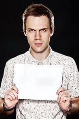 Image showing Handsome young man with cardboard