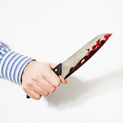 Image showing The hand  is holding the knife with blood