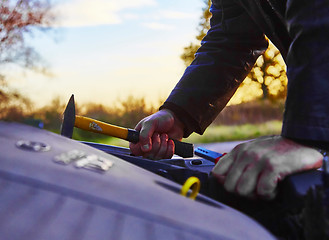 Image showing Hooligan breaking into car