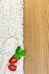 Image showing Rice white with spoon and tomatoes on board