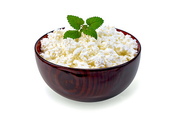 Image showing Curd in wooden bowl with mint