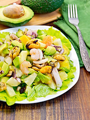 Image showing Salad seafood and avocado on dark board