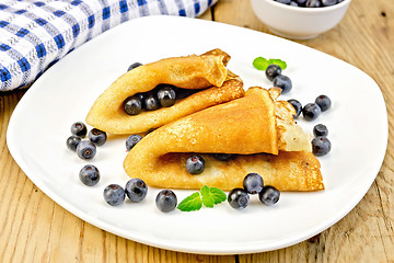 Image showing Pancakes with blueberries on wooden board