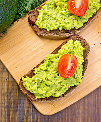Image showing Sandwich with guacamole and tomato on board