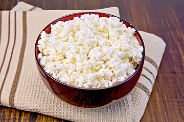 Image showing Curd in wooden bowl on board with brown cloth