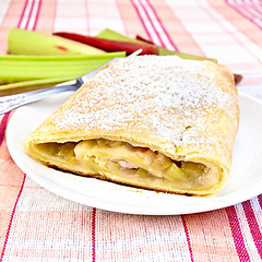 Image showing Strudel with rhubarb in plate on linen tablecloth