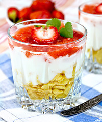 Image showing Dessert milk with strawberry and flakes in glass on napkin