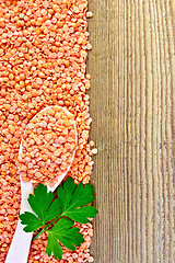 Image showing Lentils red with spoon and parsley on board
