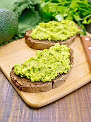 Image showing Sandwich with guacamole on dark board