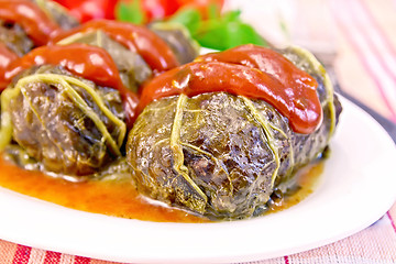 Image showing Rhubarb leaves stuffed with sauce in plate