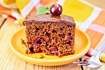 Image showing Cake chocolate with cherries and napkin on board