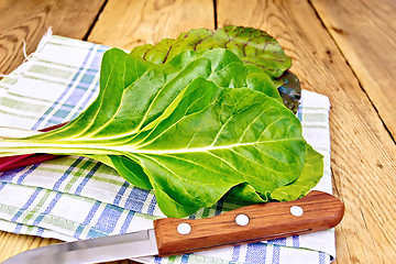 Image showing Mangold with knife and napkin on board