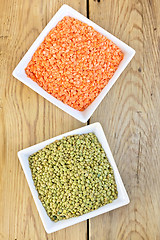 Image showing Lentils red and green in white bowls on board