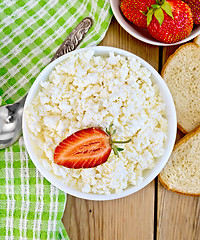 Image showing Curd with strawberries in bowl on wooden board