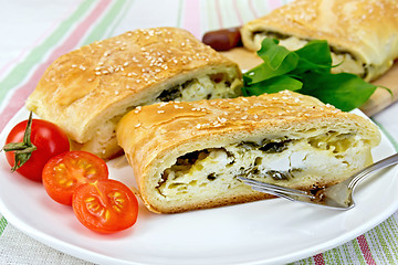 Image showing Roll filled with spinach and cheese in bowl on tablecloth