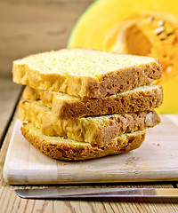 Image showing Bread pumpkin homemade slices with knife on board