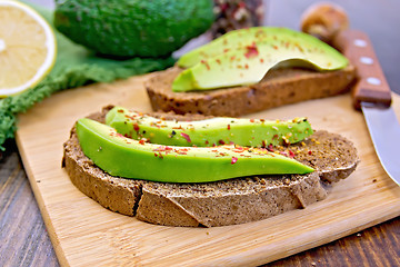 Image showing Sandwich with avocado and pepper on board