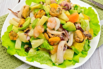 Image showing Salad seafood and avocado on light green napkin