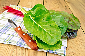 Image showing Mangold with knife on napkin and board