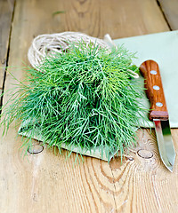 Image showing Dill green with knife and napkin on board