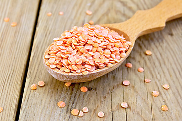 Image showing Lentils red in wooden spoon on board