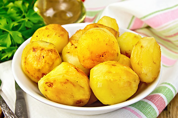 Image showing Potatoes fried in plate with oil on light board