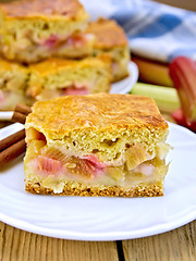 Image showing Pie rhubarb in plate on wooden board