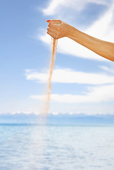 Image showing Woman hand playing with sand