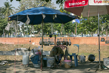 Image showing Live Fish Seller and Sleeping Dog