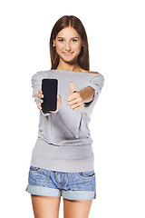 Image showing Young woman showing mobile cell phone