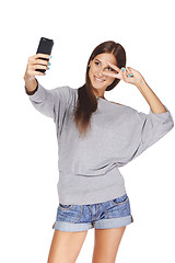 Image showing Female taking pictures of herself at smart phone