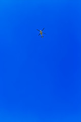 Image showing helicopter flying against a blue sky